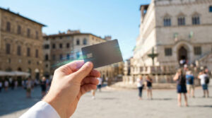 Une main tenant une carte bancaire numérique avec des effets lumineux sur une place historique européenne.